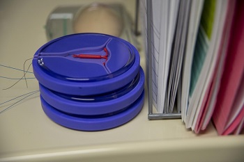 Image of a stack of IUDs in round containers