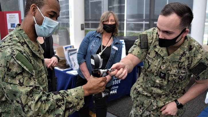 Military personnel demonstrating a grip therapy