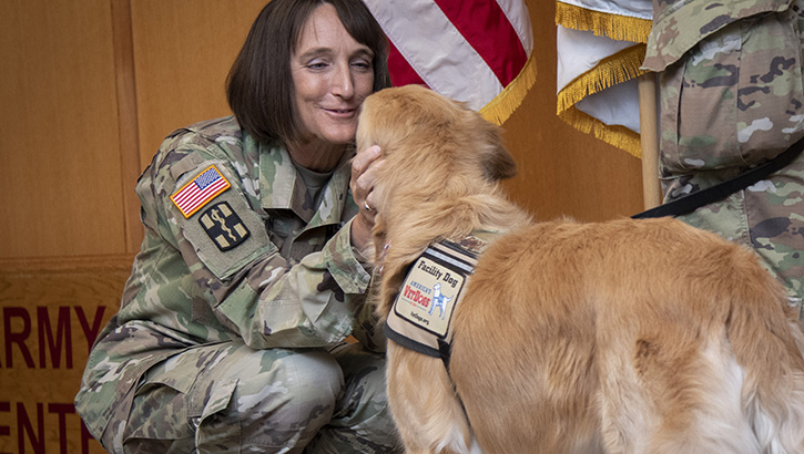  U.S. Army Brig. Gen. Deydre Teyhen, commanding general, congratulates U.S. Air Force Maj. McAfee, facility dog, upon his commissioning at Brooke Army Medical Center, Fort Sam Houston, Texas, June 6, 2023. McAfee is BAMC’s second official facility dog and the first to be commissioned into the U.S. Air Force. (DoD photo by Jason W. Edwards) 