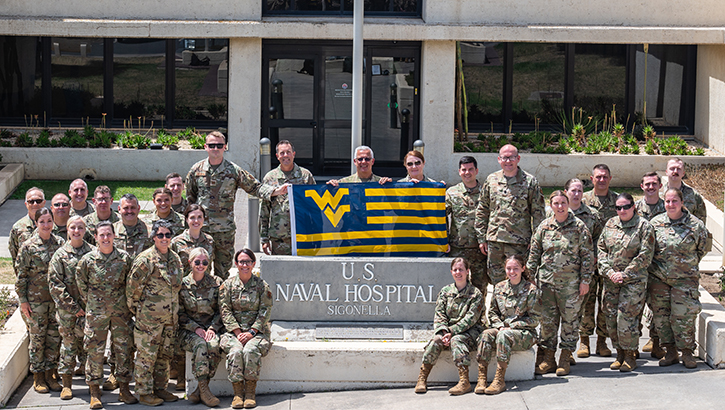 Airmen assigned to the 130th Airlift Wing, McLaughlin Air National Guard Base in West Virginia, pose for a group photo in front of the entrance to Naval Air Station Sigonella after completing their medical facility annual training on July 20, 2023. MFAT allows National Guard medical personnel to receive real-world experience in a military medical facility. (Photo: U.S Air National Guard Lt. De-Juan Hale) 