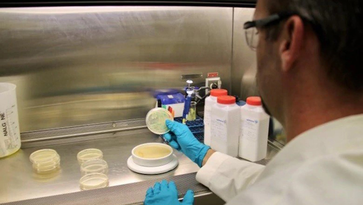 Image of Man in white coat doing experiments.