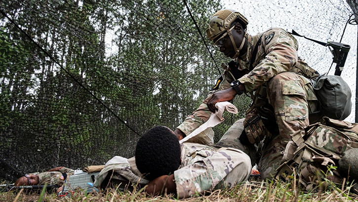 U.S. Army Spc. Ousmane Drame, a medical logistics specialist with the U.S. Army Medical Research Institute of Infectious Diseases, treats a simulated casualty during the 2023 Army Best Squad Competition at Fort Stewart, Georgia, Sept. 27, 2023. Drame, a native of Senegal who emigrated to the United States in 2018 before enlisting in the Army in 2021, is part of the Army Futures Command team at the competition. (US. Army photo by T. T. Parish)