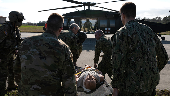 U.S. Air Force, Army and U.S. Navy service members carry a mannequin to an Army UH-60 Blackhawk for a casualty evacuation during Operation Blue Horizon 2023 at MacDill Air Force Base, Florida. (Photo by U.S. Air Force Airman 1st Class Derrick Bole) 