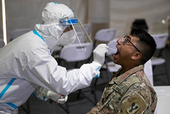 A soldier is tested for COVID-19