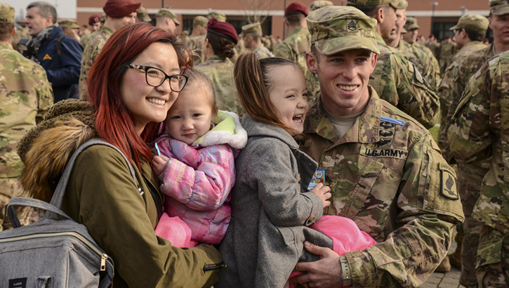Image of Military family posing for a picture.