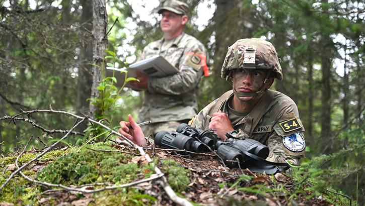 U.S. Army Spc. John Shields, front, a combat medical specialist assigned to the Iowa National Guard, conducts a spot report as U.S. Army  Staff Sgt. Steve Biteler with the South Dakota National Guard grades Shields performance during the Army National Guard’s Best Warrior Competition, in Joint Base Elmendorf-Richardson, Alaska, on July 11, 2023. (Photo by U.S. Air National Guard Master Sgt. David Eichaker)