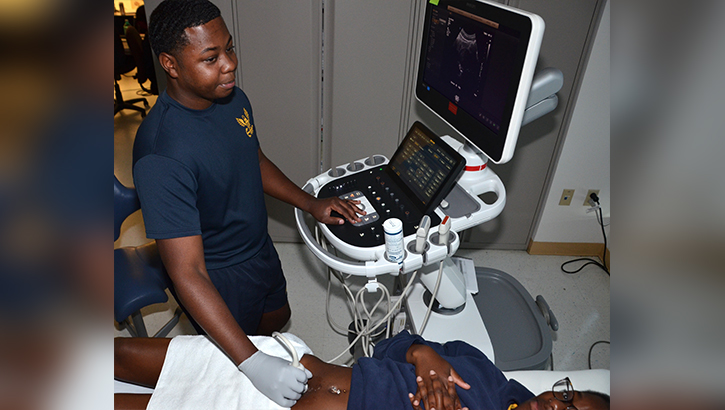 Hospital Corpsman Second Class Douglass Jones conducts a training scan in the Diagnostic Medical Sonographer program ultrasound laboratory at the Medical Education and Training Campus. Jones was praised for his outstanding attention to detail after recognizing a possible tumor in another student during a practice scan, enabling the student to receive expedited follow-up care. (Photo: Lisa Braun)