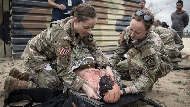 U.S. Army Capt. Morgan Bobinski and U.S. Army Capt. Lauren Blake, burn intensive care unit nurses, treat a simulated patient during the Tactical Trauma Reaction and Evacuation Crossover Course at Joint Base San Antonio-Lackland, Texas. (Photo by Jason W. Edwards, U.S. Army)