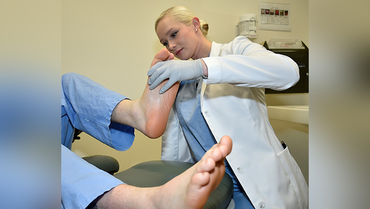 U.S. Navy Lt. Edee Renier, staff podiatrist assigned to Naval Hospital Bremerton’s  Orthopedic department shares her expertise in handling foot and ankle specific medical conditions, such as ankle sprains, strains, and fractures.  (Photo by Douglas H Stutz, Naval Hospital Bremerton public affairs officer)