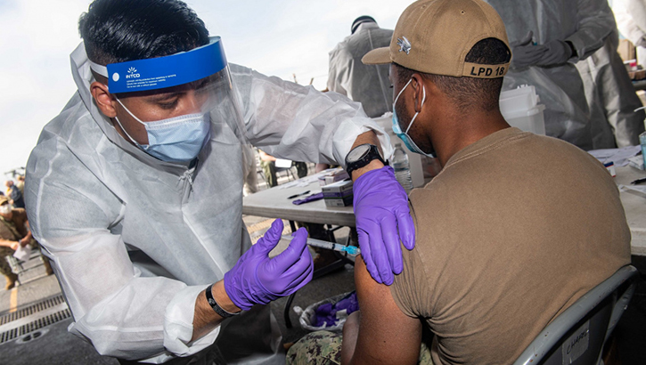 Image of Military health personnel giving the COVID-19 Vaccine to military personnel.