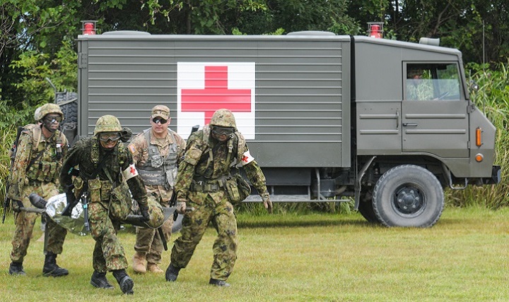 Link to Photo: Japan Ground Self-Defense Force medics carry a casualty from an ambulance to a JGSDF helicopter while a U.S. Army medic calls directions during a bilateral medical training exercise. 
