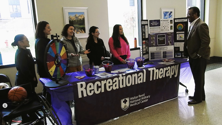 Department of Rehabilitation staff members at Walter Reed, including Recreational Therapists Cara Navarro, Stephanie Seeley, Jennifer Beattie, Jennifer Zumwalde, Meghan Campano, and Jahniya Kiliru-Liontree, recognized National Recreational Therapy Month, observed during February, with an information table set up in the America Building at the medical center Feb. 14 for patients, staff and visitors to learn about Recreational Therapy and its benefits. (DOD Photo by Bernard Little)
