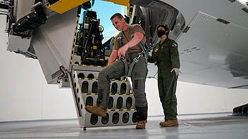 Military personnel exits aircraft centrifuge