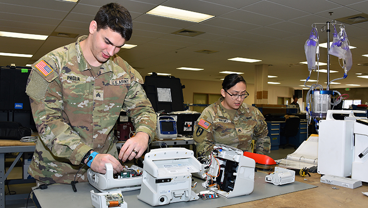 U.S. Army Sgt. Jason Paglia and U.S. Army Staff Sgt. Nora Martinez perform maintenance on patient monitors at the U.S. Army Medical Materiel Agency's Medical Maintenance Operations Division at Hill Air Force Base, Utah, Nov. 14, 2023. 