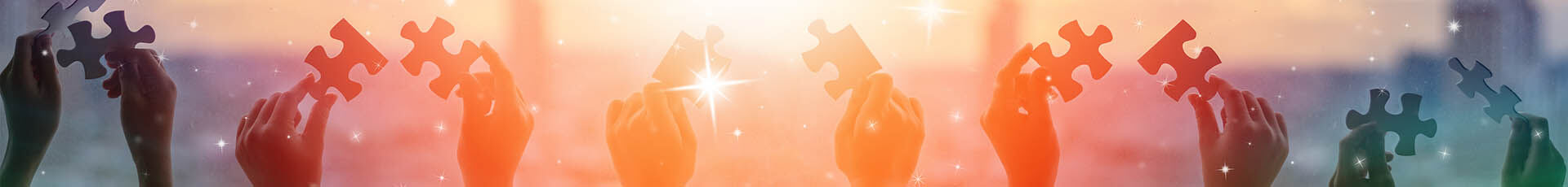 children's hands holding puzzle pieces (stock photo)